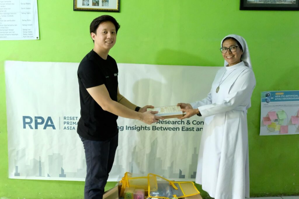 Sebastian shakes hand with the Head of St. Yakobus Surabaya Youth Center