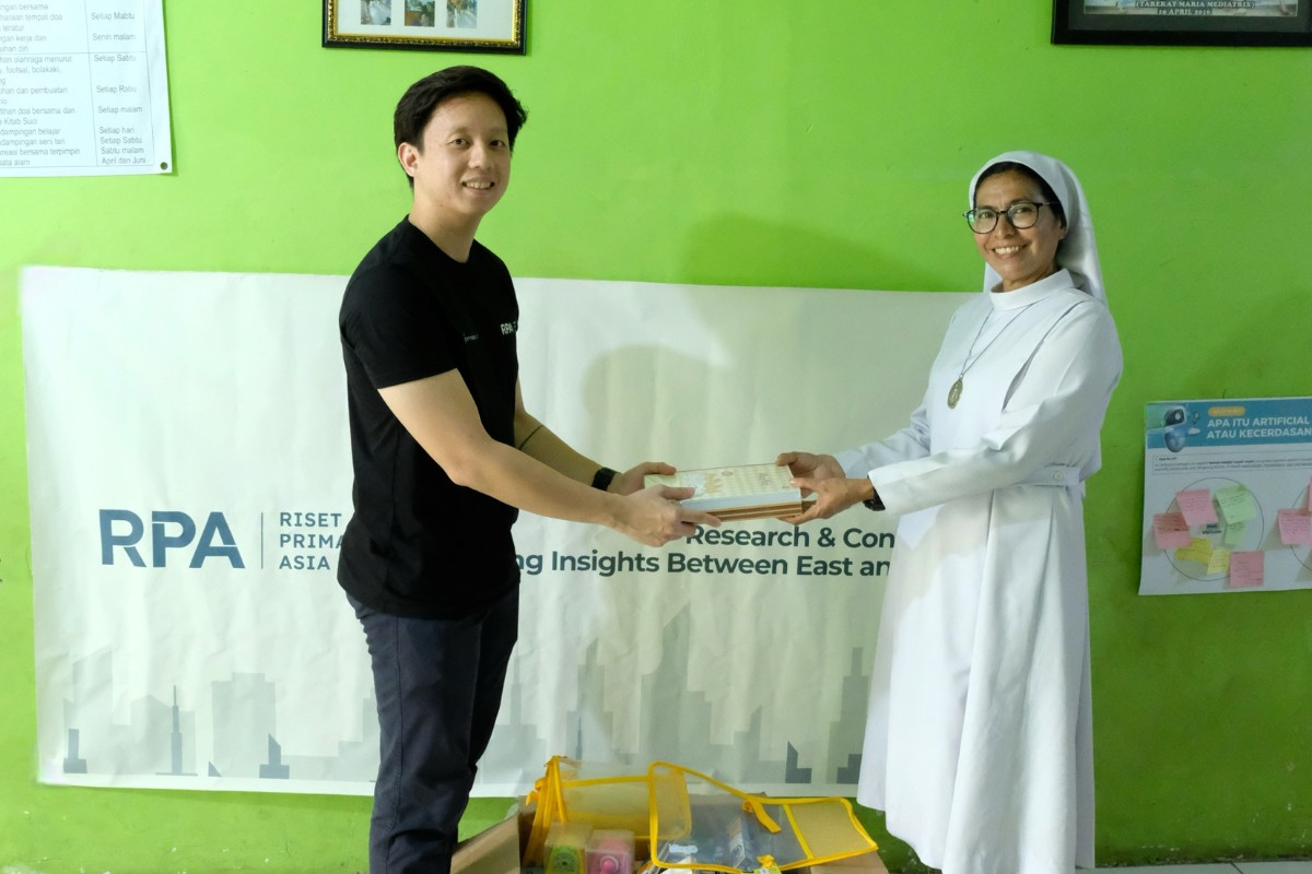 Sebastian shakes hand with the Head of St. Yakobus Surabaya Youth Center